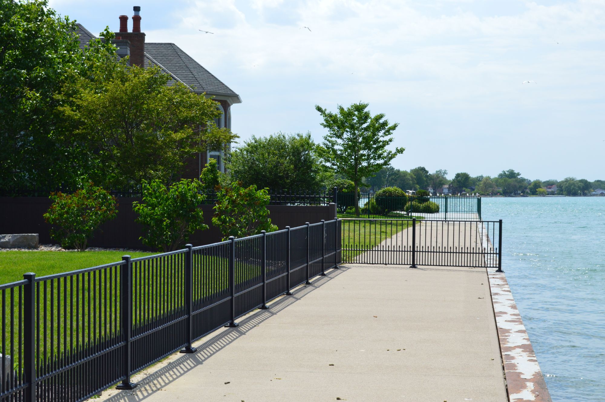 Residential Fence installation near the water with optional puppy Picket