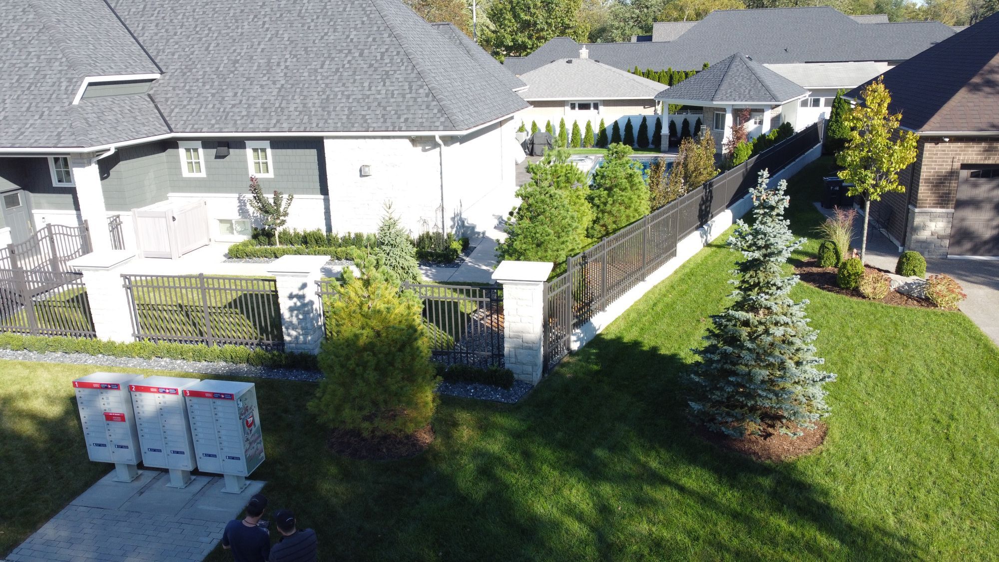 In Tecumseh, Ontario, we installed this industrial fencing around a pool. In coordination with Erie Accent pools, this metal fence makes a bold statement with stone pillars. It perfectly comes together.