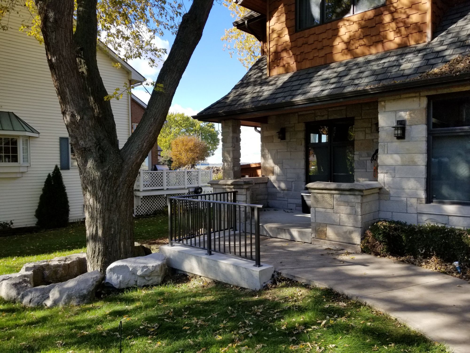 2 1/2 inch aluminum top cover railing to grace the stone entrance of this home. It$quot;s a reminder that Quaker Bronze is a timeless color that does not go out of style, which means that it will continue to look good for many years to come.