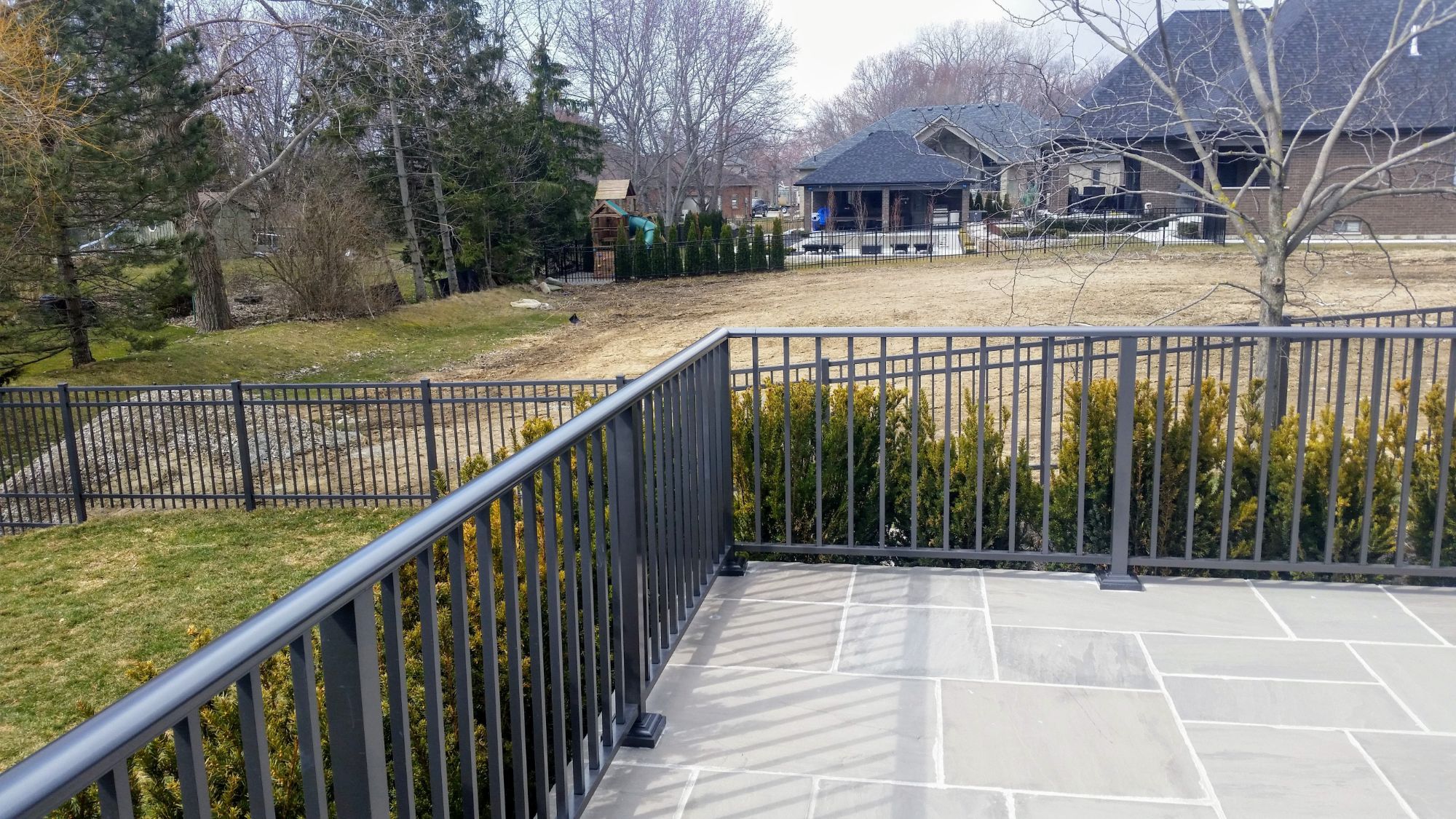 Patio railing that borders the edge of this hard-scaped patio. With 2.5 inch top cover and .75 inch pickets it made the perfect 3$quot; tall railing for the customer.