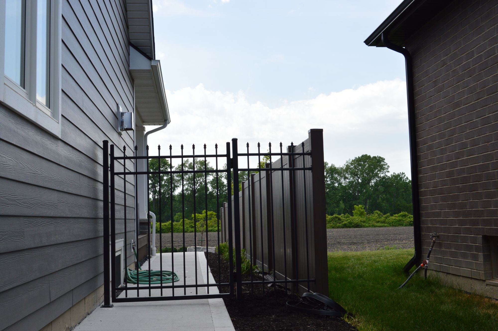Spear point aluminum gate closing off this side walk at a new build in Windsor