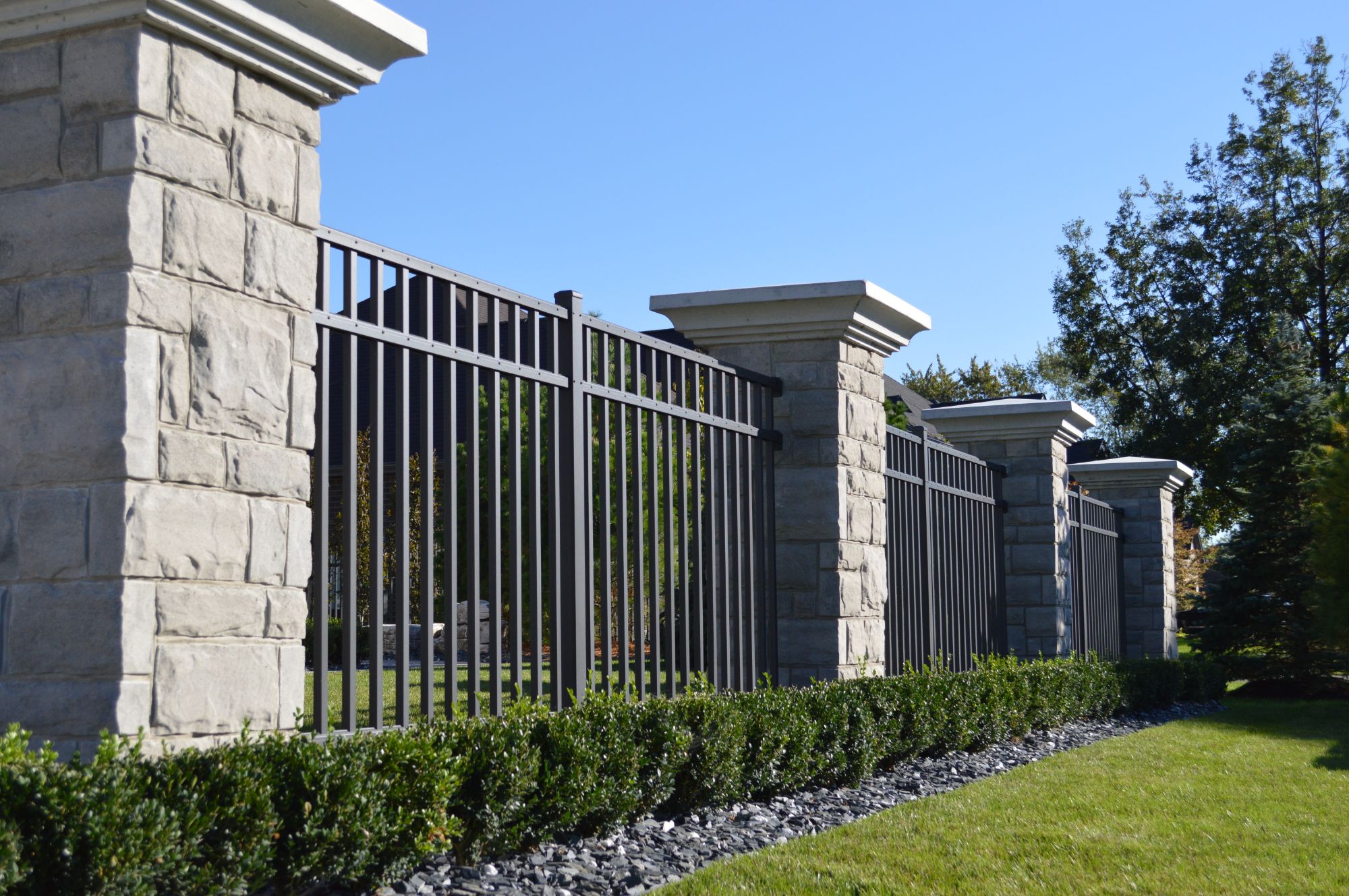 Stone columns with this industrial fence, it$quot;s a beautiful setup at 5 feet tall. When you pull up to this house, it makes a grand statement.